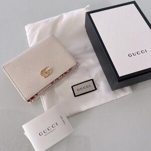 Authentic Gucci GG Mini Wallet with packaging. Excellent condition.